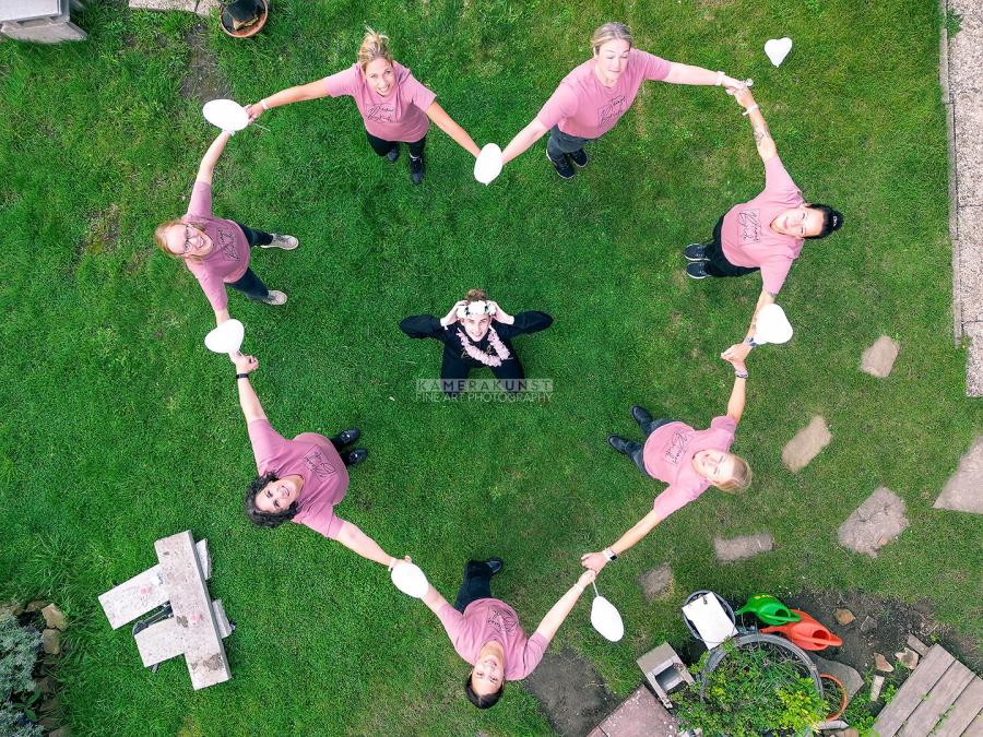 Alle haben die Braut gern: Die Freundinnen bilden bei der JGA-Fotoparty ein Herz um die Braut. Die Drohne hält diese schöne Erinnerung vor der Hochzeit fest.